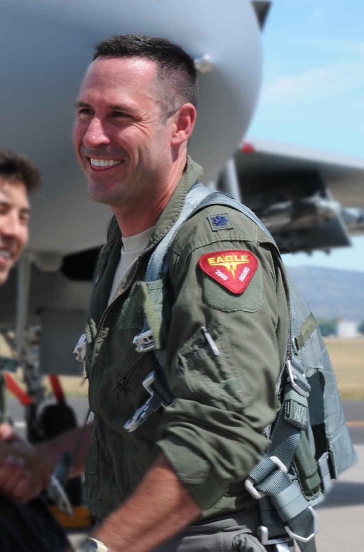Lt Col Steve Cox in flight suit beside an F-15C